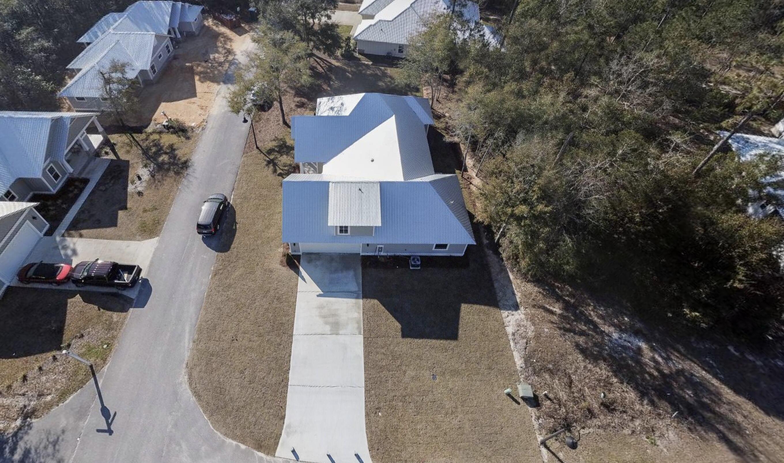 190 Bear Creek Boulevard Freeport, FL 32439 - Photo 79 of 85 an aerial view of a house with swimming pool and large trees