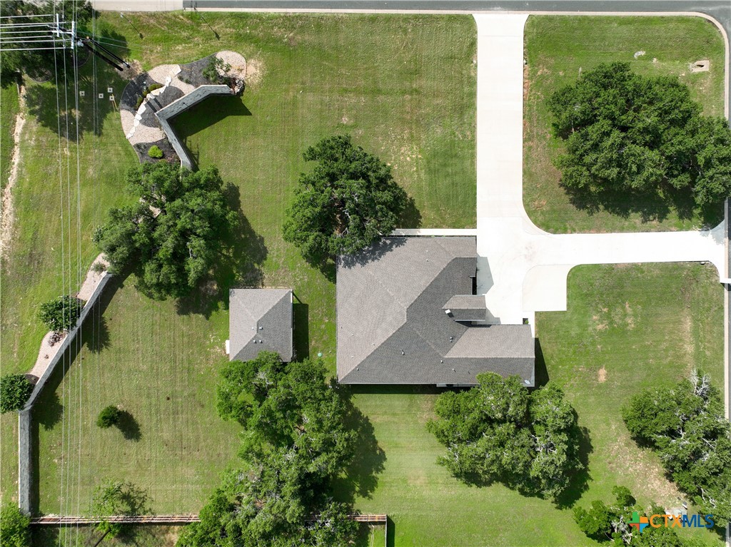 an aerial view of a residential houses with outdoor space and lake view