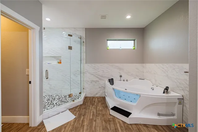 a bathroom with a bathtub and a shower