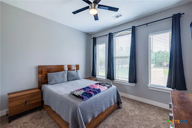 a bedroom with a bed and window