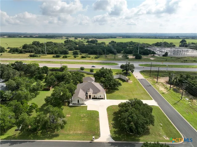 an aerial view of a residential houses with outdoor space and swimming pool