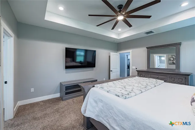 a bedroom with a bed and a flat screen tv