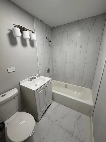 a bathroom with a sink a toilet and bathtub