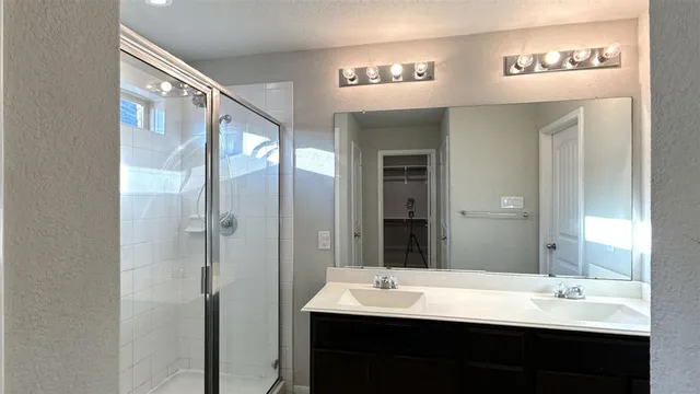 a bathroom with a tub sink and shower