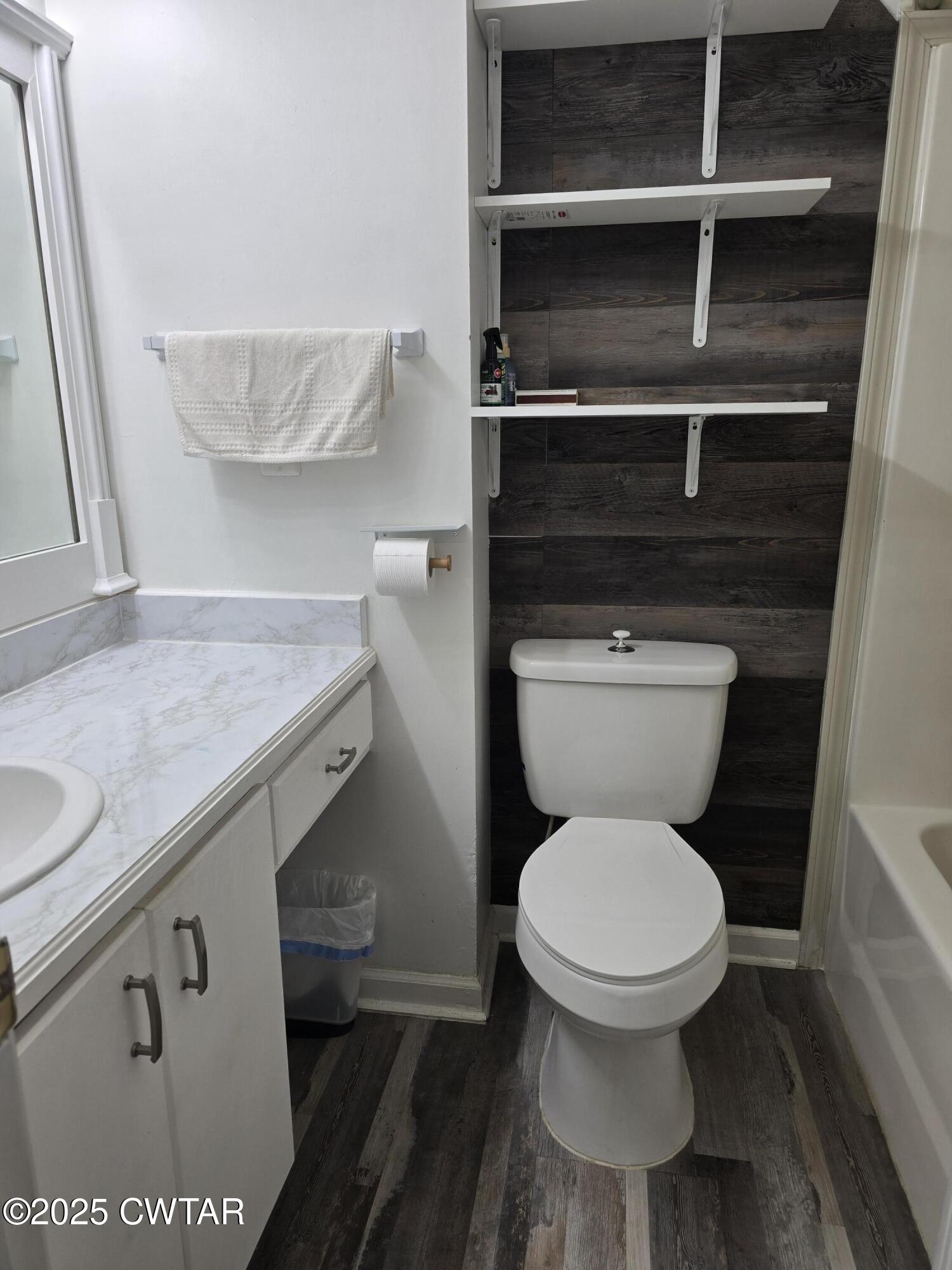 143 Elizabeth Cove Selmer, TN 38375 - Photo 13 of 14 a bathroom with a granite countertop toilet and a sink