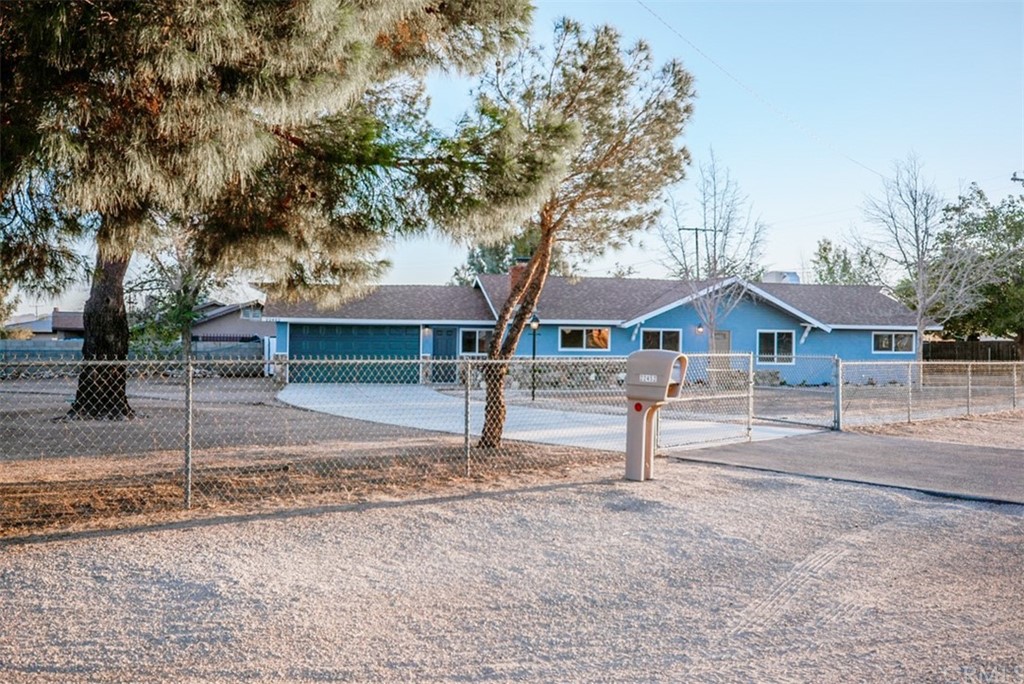 22452 Sioux Road Apple Valley, CA 92308 - Photo 1 of 1 a front view of a house with a yard