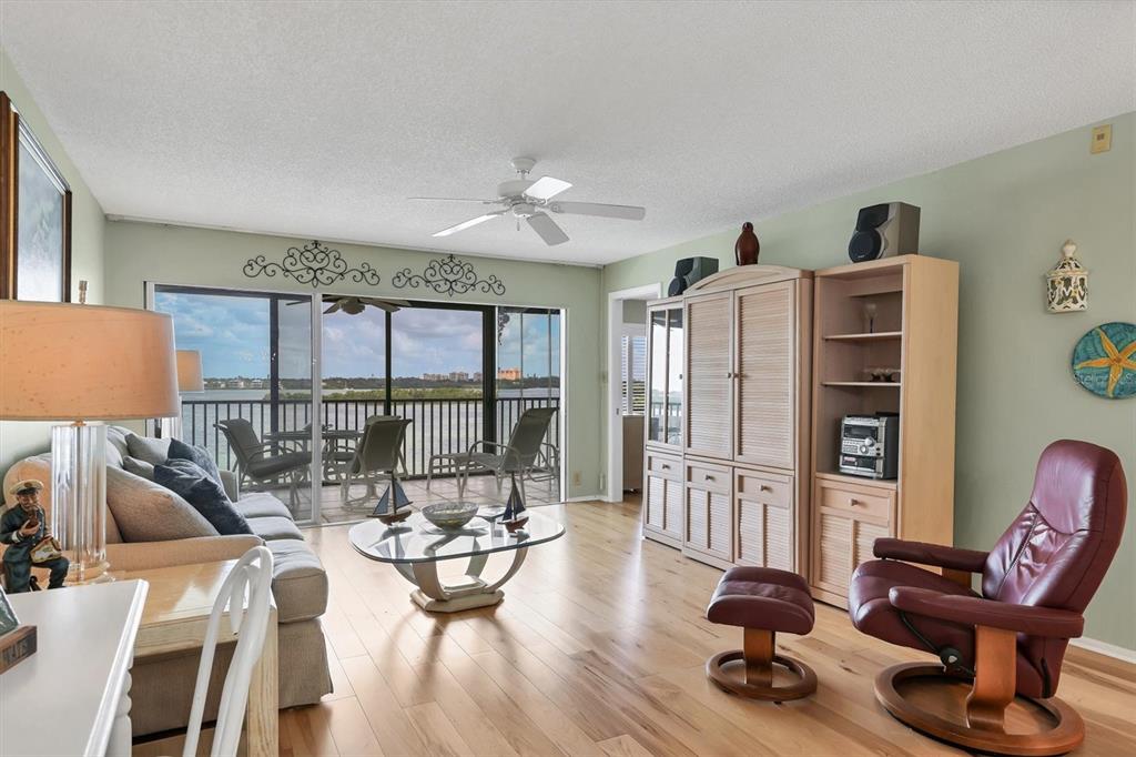 9011 Midnight Pass Road, Unit 426 Sarasota, FL 34242 - Photo 11 of 53 a view of a livingroom with furniture hardwood floor and a ceiling fan