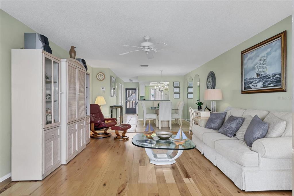 9011 Midnight Pass Road, Unit 426 Sarasota, FL 34242 - Photo 12 of 53 a living room with furniture and a chandelier