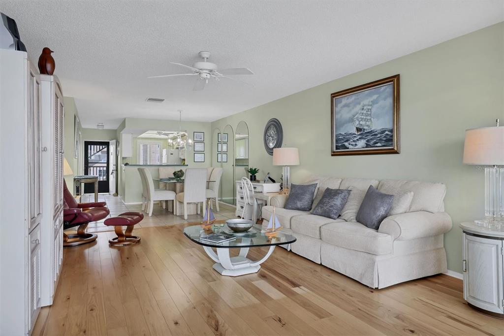 9011 Midnight Pass Road, Unit 426 Sarasota, FL 34242 - Photo 13 of 53 a living room with furniture a rug and a large mirror