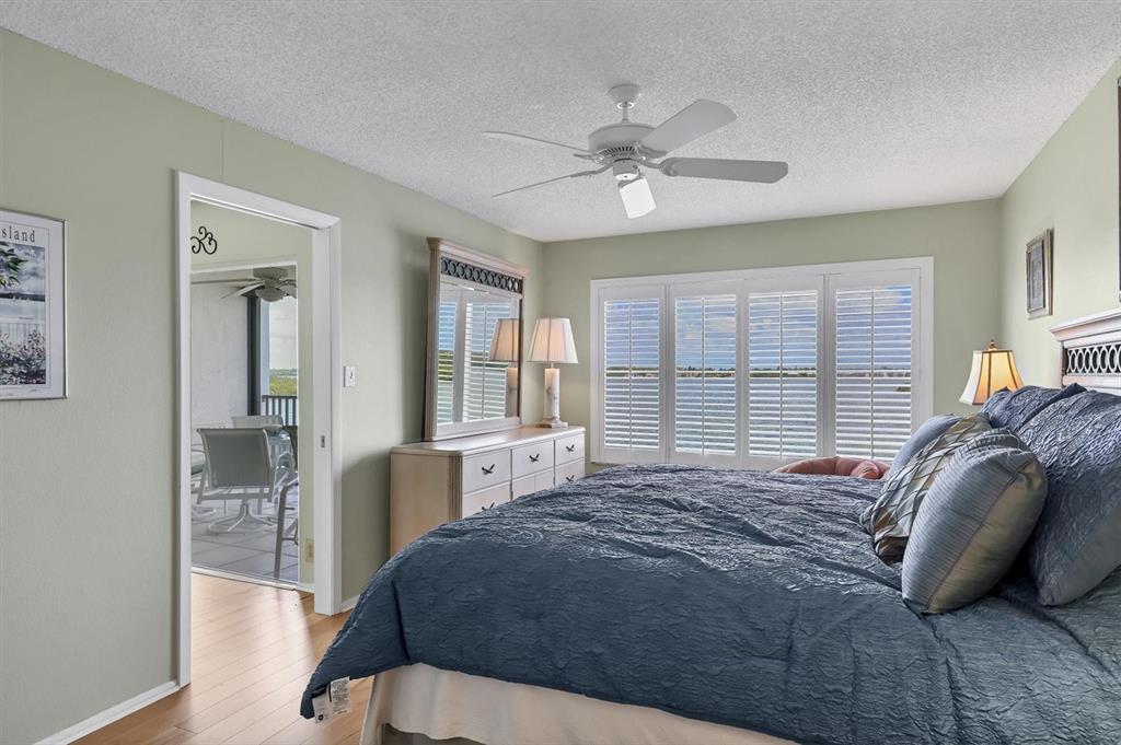 9011 Midnight Pass Road, Unit 426 Sarasota, FL 34242 - Photo 21 of 53 a bedroom with a large bed and a large window