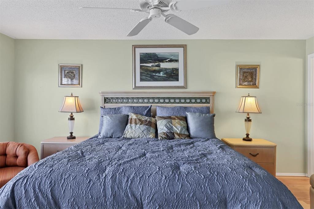 9011 Midnight Pass Road, Unit 426 Sarasota, FL 34242 - Photo 22 of 53 a bedroom with a bed and a chandelier