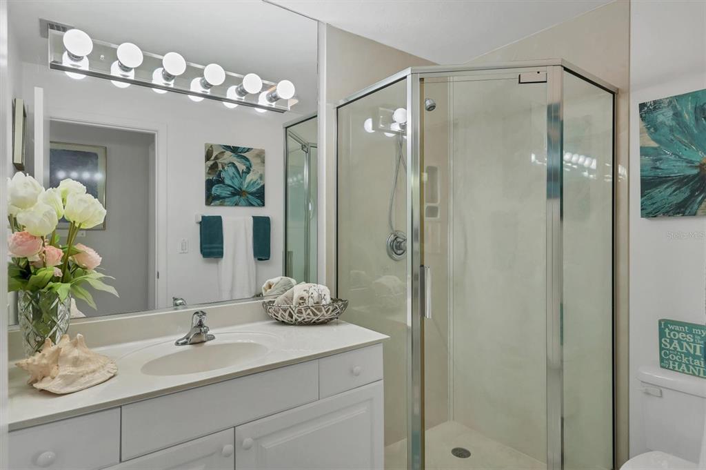 9011 Midnight Pass Road, Unit 426 Sarasota, FL 34242 - Photo 26 of 53 a bathroom with a sink vanity granite and a mirror