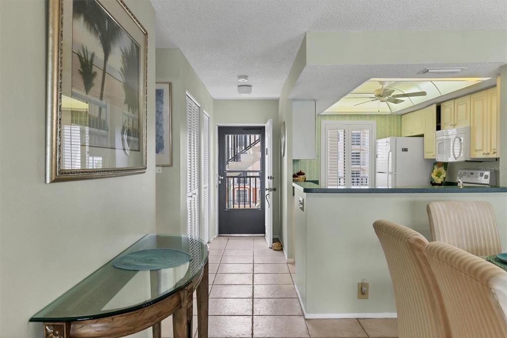9011 Midnight Pass Road, Unit 426 Sarasota, FL 34242 - Photo 9 of 53 a view of a dining room with furniture and a chandelier