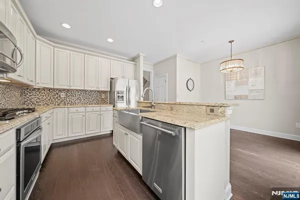 a kitchen with a stove top oven sink and cabinets