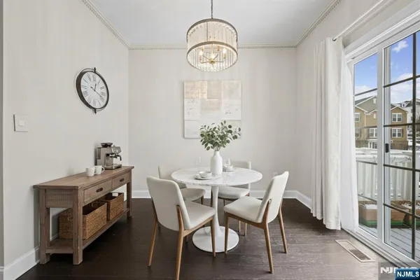 a dining room with furniture a chandelier and a rug