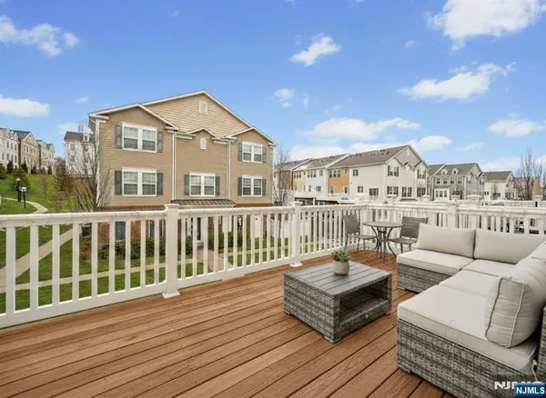 a view of a roof deck with couches and sky view