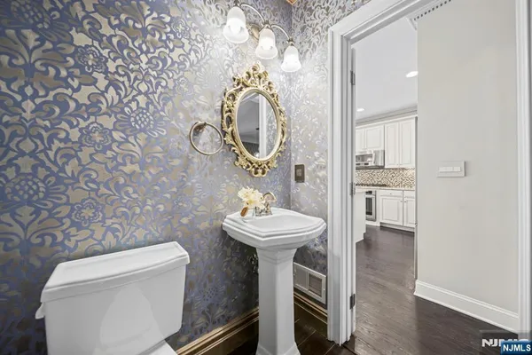a bathroom with a sink mirror and toilet