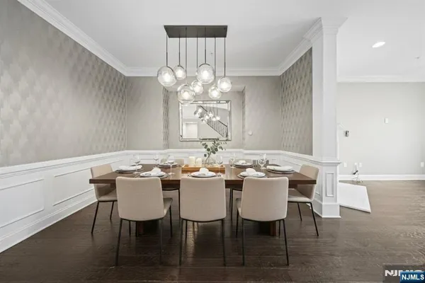 a view of a dining room with furniture and chandelier