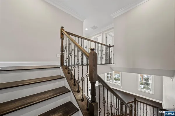a view of staircase with wooden floor and a window