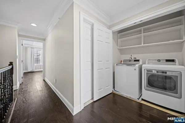a view of a kitchen with wooden floor and electronic appliances