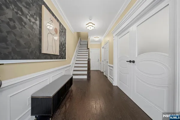 a view of a hallway with wooden floor and staircase