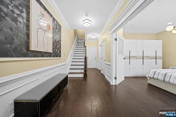 a view of a hallway with wooden floor and staircase