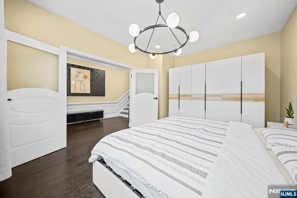 a bedroom with a bed and a chandelier