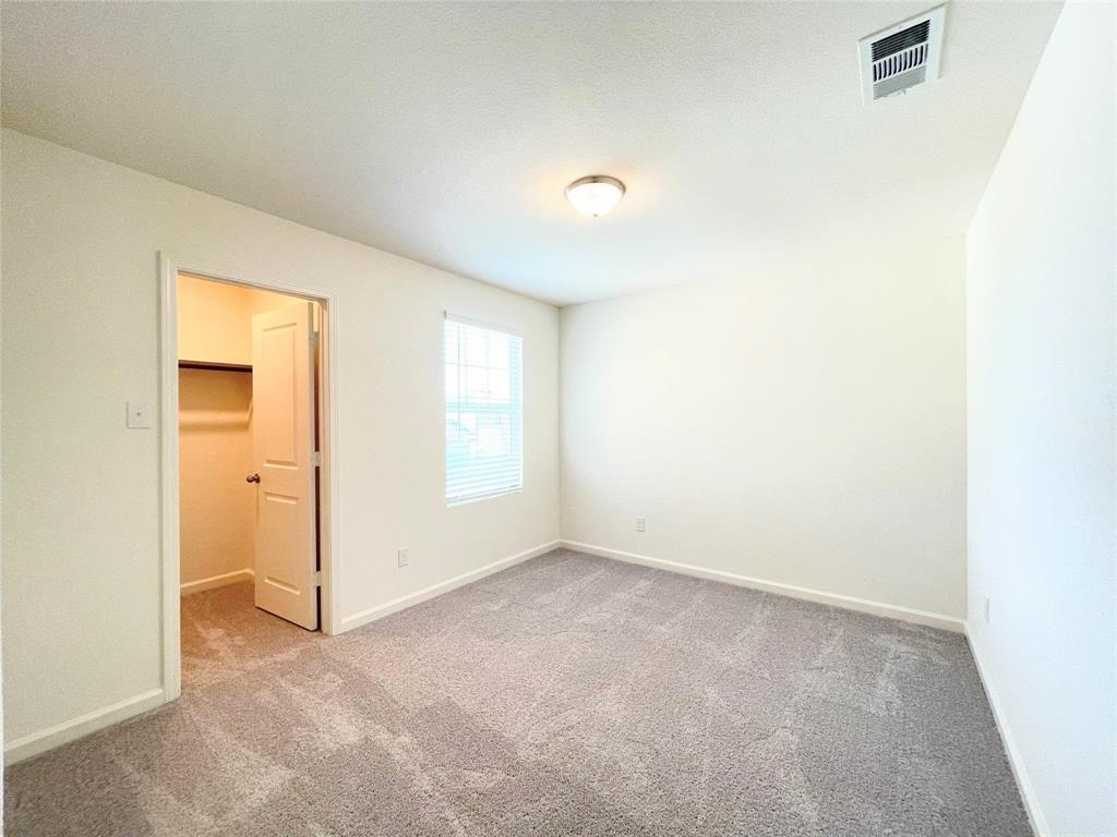 1702 Chapel Hl Road Princeton, TX 75407 - Photo 11 of 24 an empty room with windows and closet