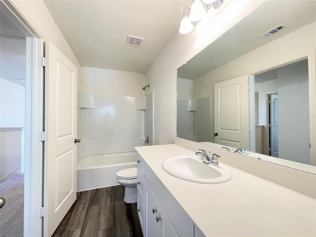 1702 Chapel Hl Road Princeton, TX 75407 - Photo 14 of 24 a bathroom with a sink a toilet a mirror and shower