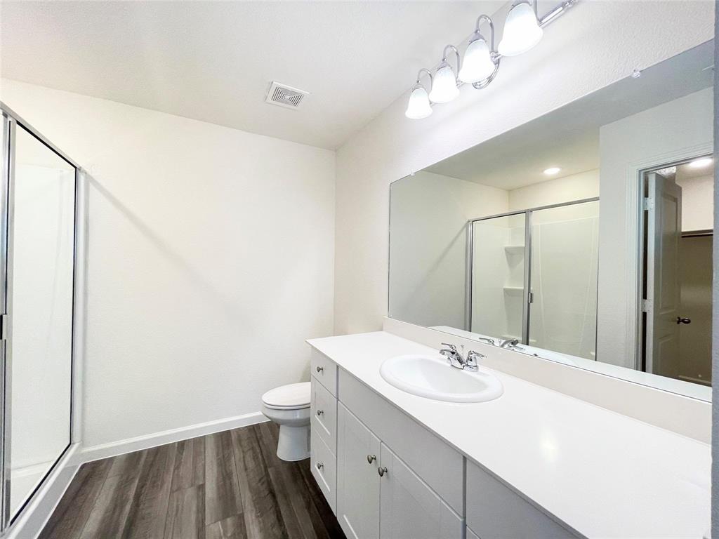 1702 Chapel Hl Road Princeton, TX 75407 - Photo 17 of 24 a bathroom with a sink a toilet and a mirror