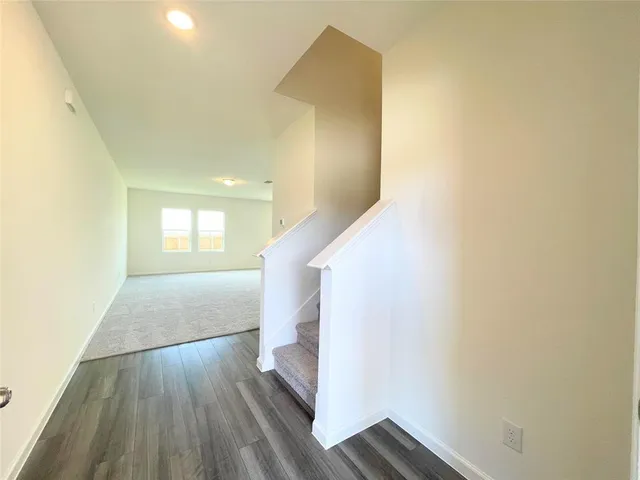a view of livingroom and hallway with wooden floor