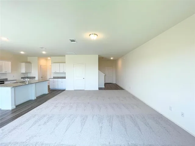 a view of a kitchen with a sink and cabinets