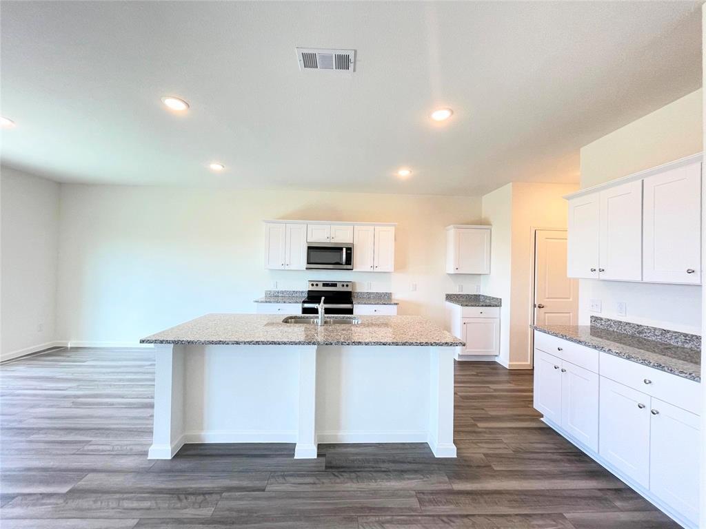 1702 Chapel Hl Road Princeton, TX 75407 - Photo 5 of 24 a kitchen with stainless steel appliances kitchen island sink refrigerator and cabinets