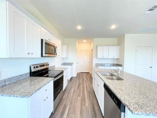 a kitchen with a sink stove and microwave