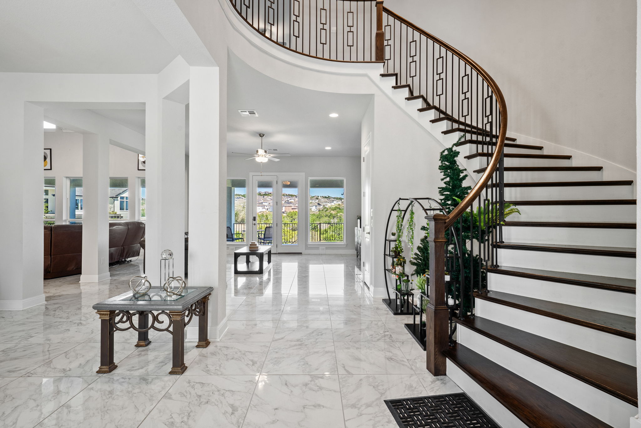 2132 Novara Trail Leander, TX 78641 - Photo 26 of 40 Entryway featuring light marble finish floors, a high ceiling, ceiling fan, and recessed lighting