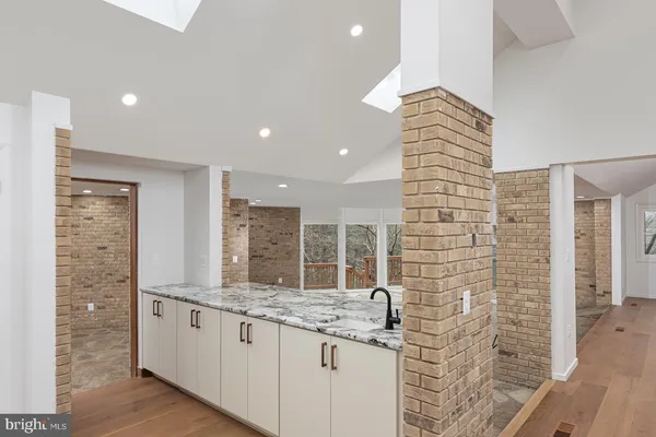 a view of a room with wooden floor and windows