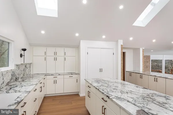a view of a room with wooden floor and windows