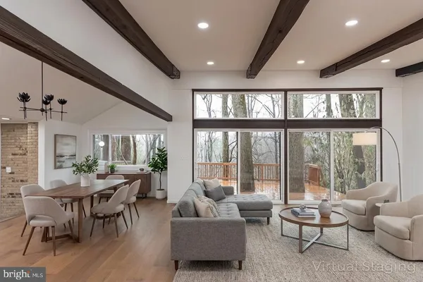 a view of an empty room with wooden floor and windows