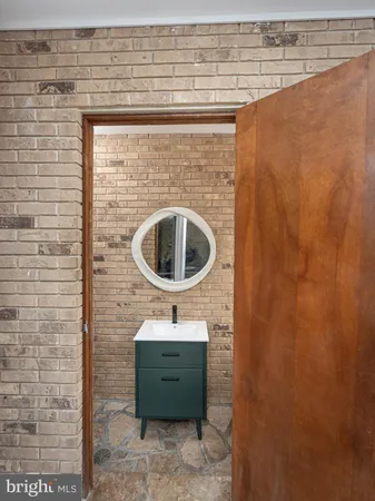 a view of empty room with wooden floor and entryway
