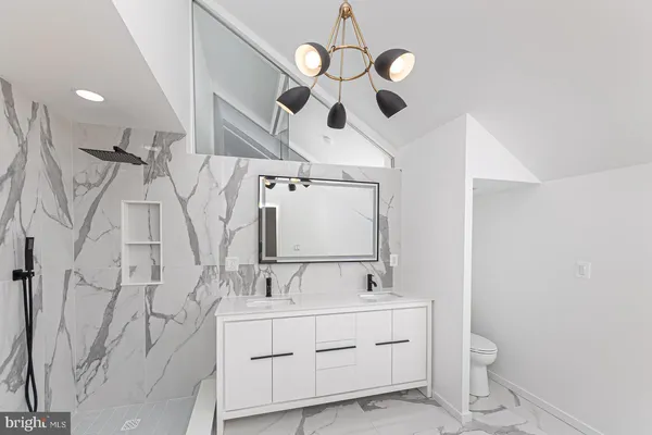 a bathroom with a sink a mirror and vanity