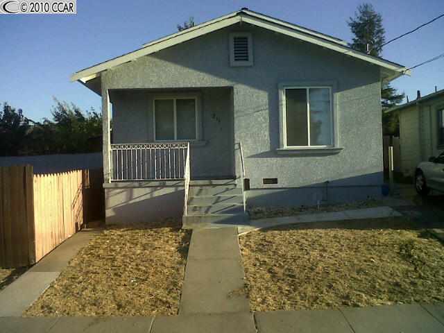 211 Third Street Rodeo, CA 94572 - Photo 1 of 1 a front view of a house with a yard