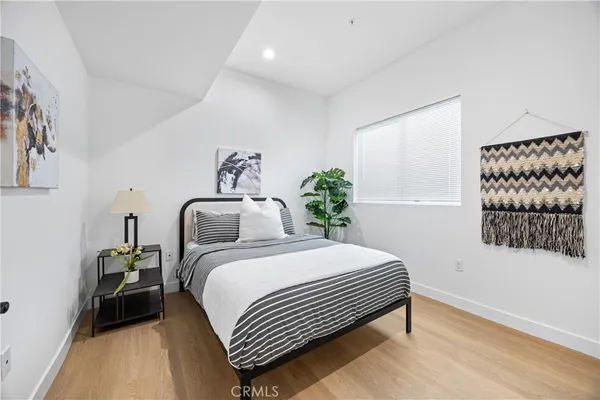 a bedroom with a bed and a painting on the wall