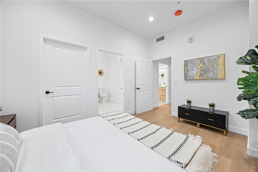 13857 Leffingwell Road Whittier, CA 90604 - Photo 13 of 32 a bedroom with a bed and a potted plant