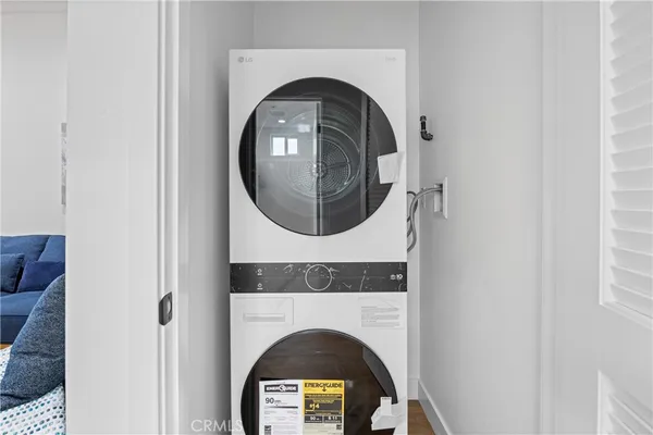 a close view of utility room with a wooden floor and a mirror