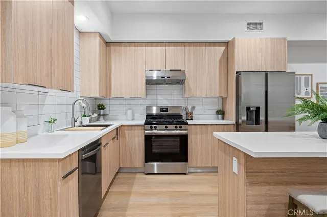 a kitchen with a stove a refrigerator and a sink