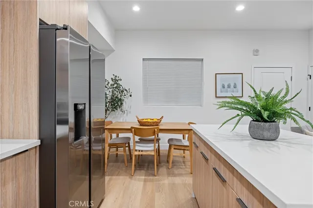 a dining room with furniture and potted plant