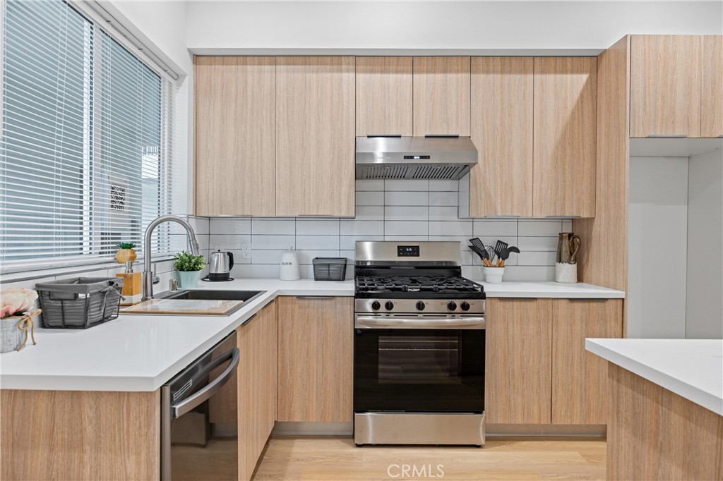 13857 Leffingwell Road Whittier, CA 90604 - Photo 2 of 32 a kitchen with a stove a sink and a cabinets