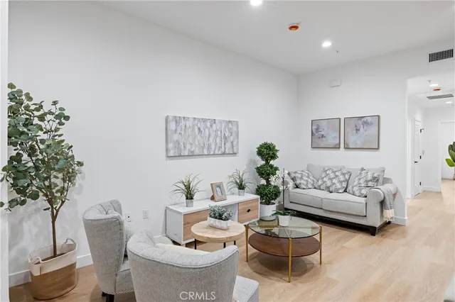 a living room with furniture and a potted plant