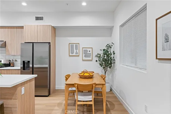 a kitchen with granite countertop stainless steel appliances a refrigerator and a stove