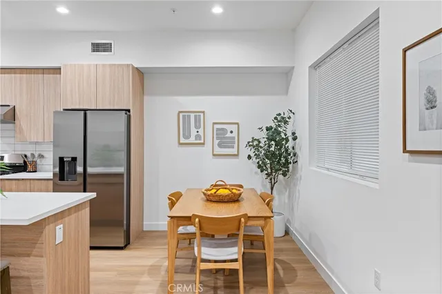 a kitchen with granite countertop stainless steel appliances a refrigerator and a stove